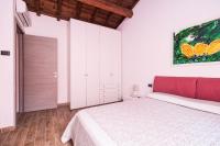a bedroom with a bed and a painting on the wall at Villa Broglia House in Verona