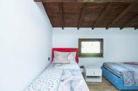 a bedroom with two beds and a window at Villa Broglia House in Verona