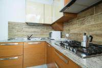a kitchen with wooden cabinets and a stove top oven at Villa Broglia House in Verona