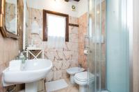 a bathroom with a sink and a toilet and a shower at Villa Broglia House in Verona