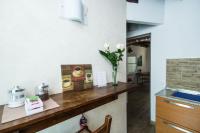 a kitchen with a counter with a vase of flowers at Villa Broglia House in Verona
