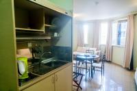 a kitchen with a sink and a table in a room at Hotel Maharajah in Mamoudzou