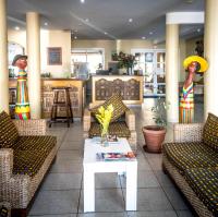 a lobby with couches and a table with flowers on it at Hotel Maharajah in Mamoudzou
