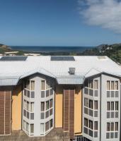 an apartment building with solar panels on the roof at Hotel Maharajah in Mamoudzou
