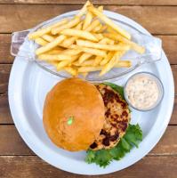 a white plate with a sandwich and french fries at Hotel Maharajah in Mamoudzou
