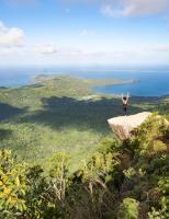 a person standing on a rock with their arms in the air at Hotel Maharajah in Mamoudzou
