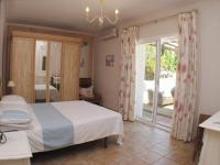 Postel nebo postele na pokoji v ubytování Villa Jacaranda