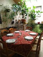 a table with plates and wine glasses on it at Chambre d&#39;hôtes Le Moulin de Moulis in Moulis-en-Médoc