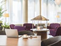 a laptop on a table in a room with purple chairs at Radisson Blu Plaza Hotel, Oslo in Oslo