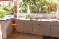 a kitchen with a sink and a large window at Villa Kannel in Petit-Bourg