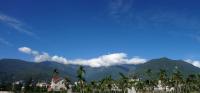 a view of a city with palm trees and mountains at Pretty Sun B&amp;B in Ji&#39;an