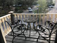 a table and two chairs on a balcony at Foley House Inn in Savannah