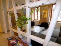 a loft bed in a living room with plants at Gite hyper centre 10 pers in Colmar