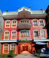 a red brick building with a newya homes sign on it at Newa Home in Kathmandu
