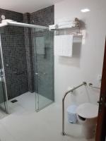 a bathroom with a glass shower and a toilet at Pousada la Portella in Cabo Frio
