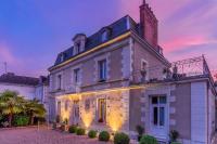 a large house with a sunset in the background at Le Pavillon des Lys - Hôtel Particulier in Amboise