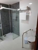 a bathroom with a glass shower and a toilet at Pousada la Portella in Cabo Frio