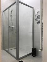 a shower with a glass door in a bathroom at Manyi Apartman in Debrecen