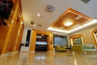 a lobby with couches and chairs in a building at Dynasty Hotel in Tainan