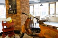 a scooter parked in a room with a brick wall at Dynasty Hotel in Tainan