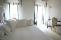A bed or beds in a room at Milano Suites