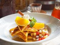 a white plate of food with waffles and fruit at Sarikantang Resort & Spa, Koh Phangan in Haad Rin