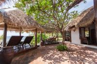 a patio with chairs and a house with a view of the ocean at Sarikantang Resort & Spa, Koh Phangan in Haad Rin