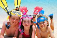 a group of people laying on the beach with theiranas at Sarikantang Resort & Spa, Koh Phangan in Haad Rin