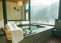 a bathroom with a sink and a tub with towels at Tangyue Resort in Tai&#39;an