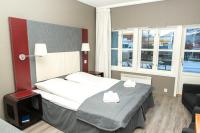 a hotel room with a bed and a chair at Oppdal Gjestetun Hotell in Oppdal