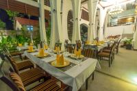 ein Restaurant mit Tischen und Stühlen und gelben Servietten in der Unterkunft The Night Hotel in Siem Reap