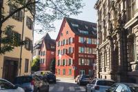 a group of buildings on a street with parked cars at Hôtel Du Dragon in Strasbourg