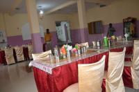 a long table with a red and white table cloth at Hotel Maurya Vihar Bodhgaya in Bodh Gaya