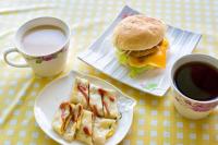 two plates of food with a sandwich and a cup of coffee at 好趣淘休閒民宿 電梯 車位預約制 in Hualien City