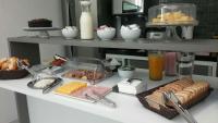 a table with a buffet of food on it at Pousada la Portella in Cabo Frio