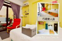 a room with two beds and a red chair at STSP Guest House in Xinshi