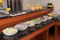 a buffet line with bowls of food on it at F Hotel - Chiayi in Fanlu