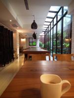 a cup of coffee sitting on a wooden table at Lan Kwai Fong Garden Hotel in Chiayi City