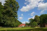 a house in a field with a barn and trees at Zur Sommerfrische Lothramühle in Drognitz