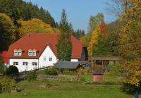 a large white house with a red roof at Zur Sommerfrische Lothramühle in Drognitz