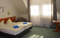 a bedroom with a bed with blue towels on it at Zur Sommerfrische Lothramühle in Drognitz