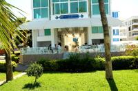 A garden outside Olimpos Beach Hotel by RRH&R