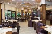 a dining room with tables and chairs in a restaurant at Hotel St Valentine all inclusive in Sunny Beach