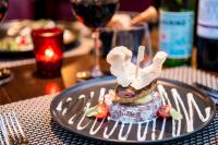 a plate with food on a table with a wine glass at Charmehotel Klokkenhof in Brasschaat