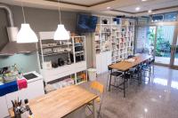 a kitchen and dining room with a table and chairs at Dali Yi International Hostel in Toucheng