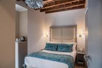 A bed or beds in a room at Reginella Suites