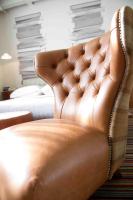 a brown leather chair sitting in a room at ABode Manchester in Manchester