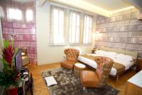 a bedroom with a bed and a chair in a room at ABode Manchester in Manchester