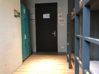 a hallway with two black doors and a wooden floor at Taipei Discover Hostel in Taipei