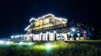 a building with lights in front of it at night at Fully One B&amp;B in Taitung City